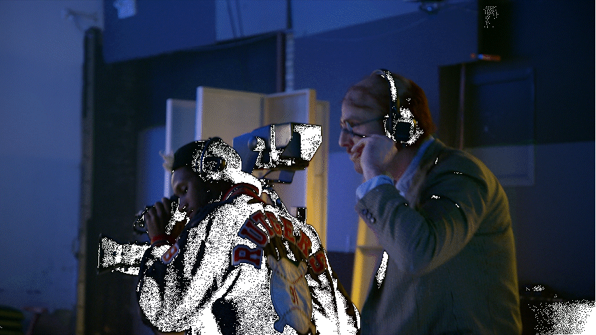 a man with headphones on talking on a cell phone