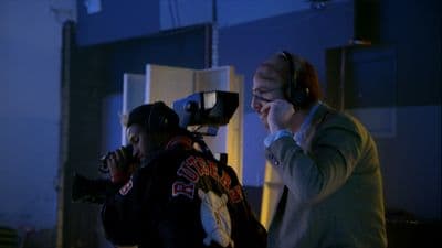 a man with headphones on talking on a cell phone