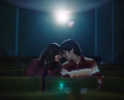 a man and a woman are sitting in a theater