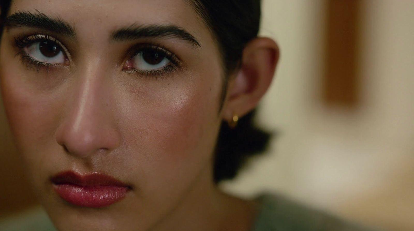 a close up of a woman's face with dark hair