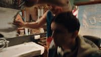 a man getting his hair cut in a barber shop