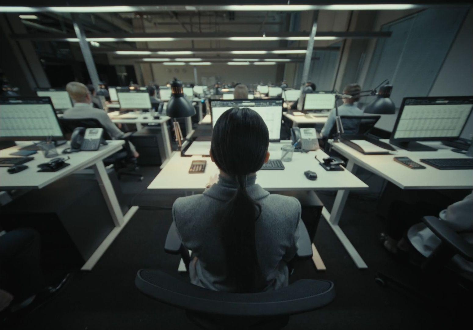 a woman sitting at a desk in an office