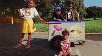 a group of children standing around a ice cream cart