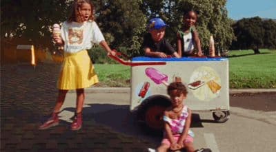 a group of children standing around a ice cream cart