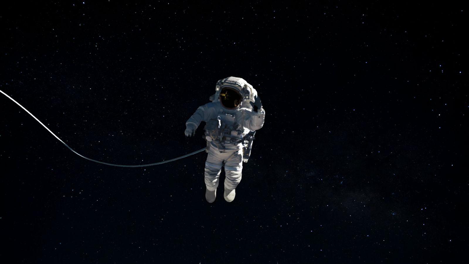 a man in a space suit floating in the air