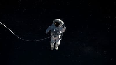 a man in a space suit floating in the air