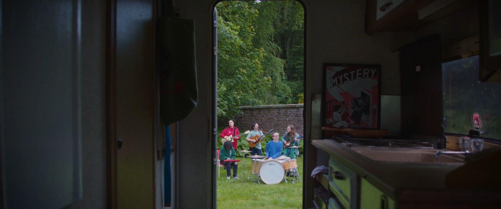 a group of people playing drums in a room