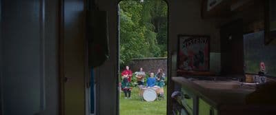 a group of people playing drums in a room