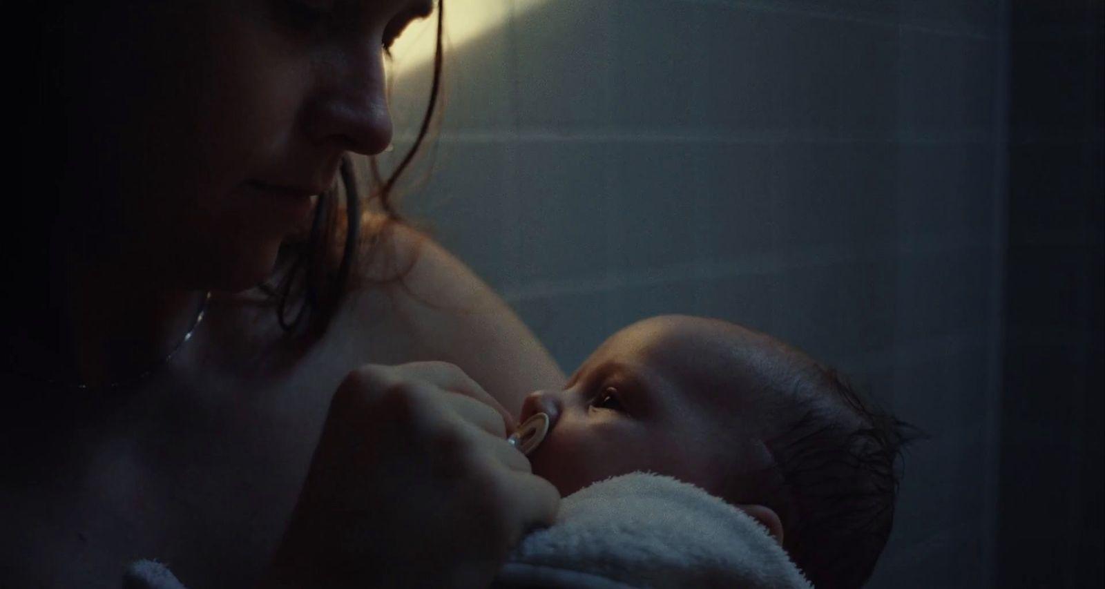 a woman holding a baby in her arms
