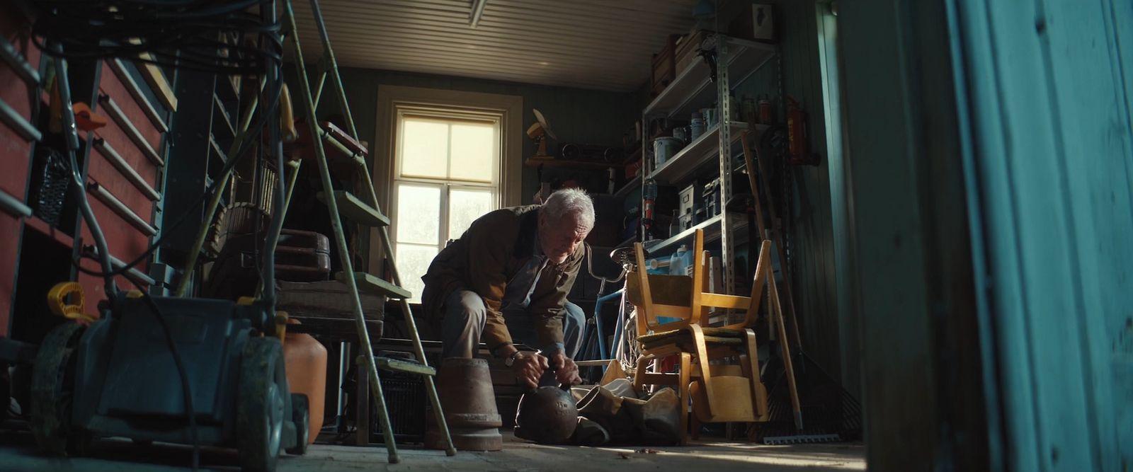 a man working on a piece of furniture in a room