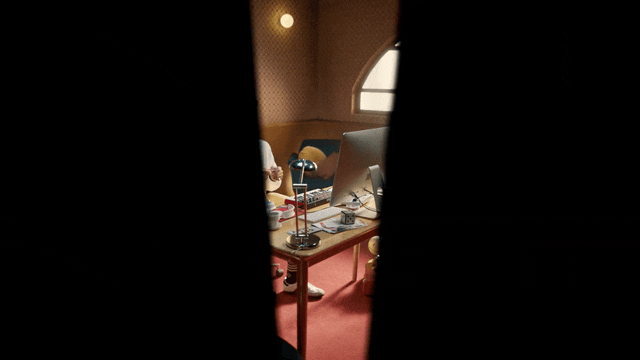 a room with a desk and a lamp in it