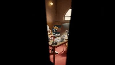 a room with a desk and a lamp in it