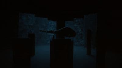 a person standing in the dark with their arms outstretched