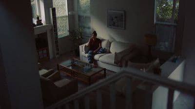 a person sitting on a couch in a living room