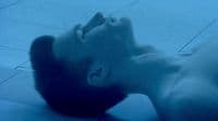 a man laying on the floor with his head in the air