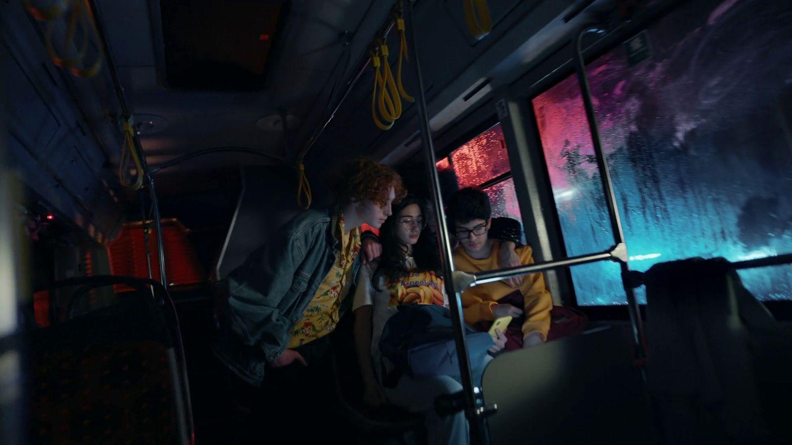 a group of people riding on a bus at night