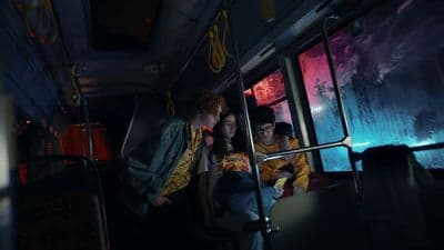 a group of people riding on a bus at night