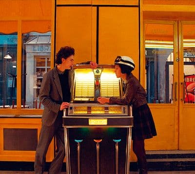 a man and a woman standing next to a vending machine