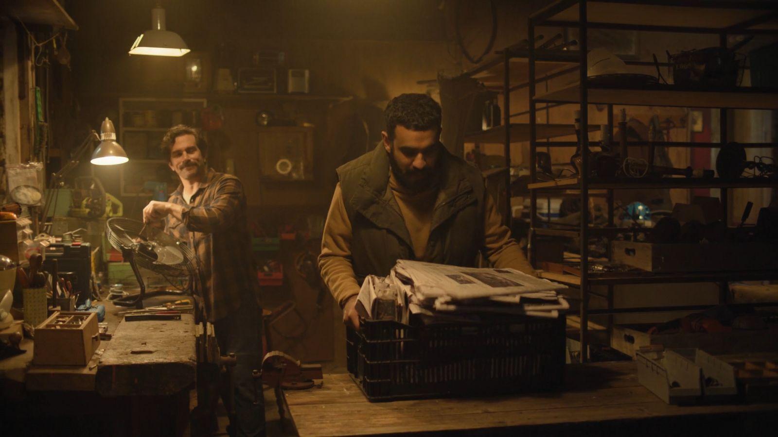 a couple of men standing next to each other in a room