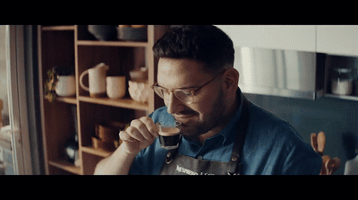 a man holding a spoon in his right hand