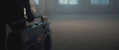 a person standing next to a radio in a dark room