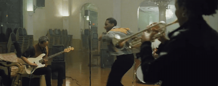 a group of people playing instruments in a room