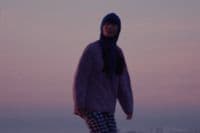 a blurry photo of a person walking on a beach