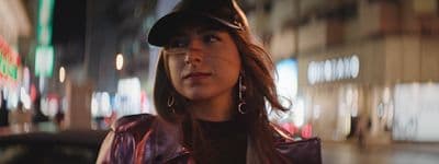 a woman wearing a hat and a leather jacket