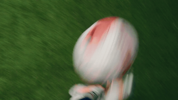 a blurry photo of a person holding a football