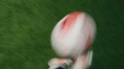 a blurry photo of a person holding a football