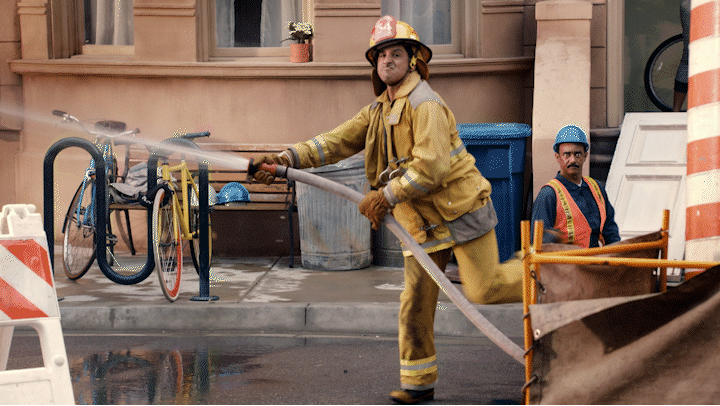 a fireman is using a hose to put out a fire