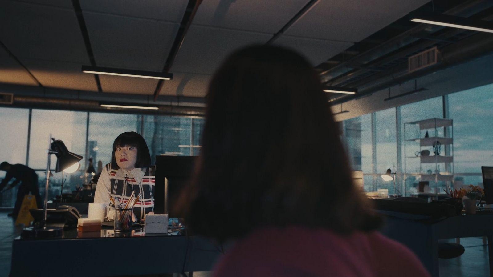 a woman standing in front of a window