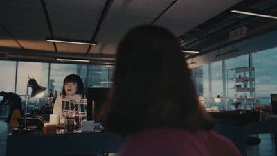 a woman standing in front of a window