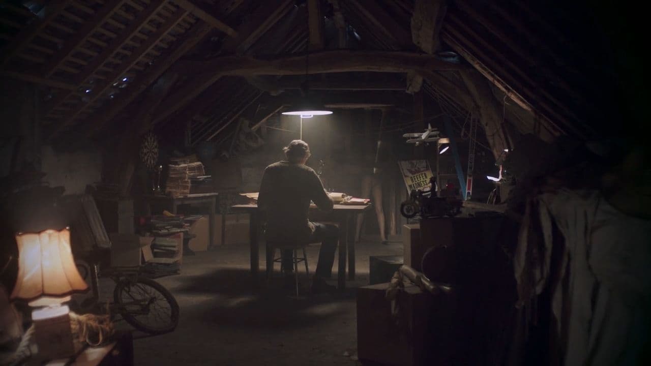 a person sitting at a table in a dark room