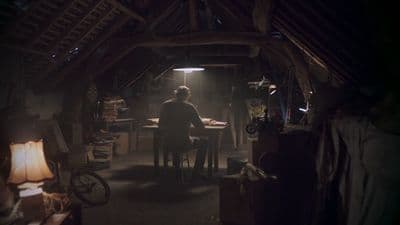 a person sitting at a table in a dark room