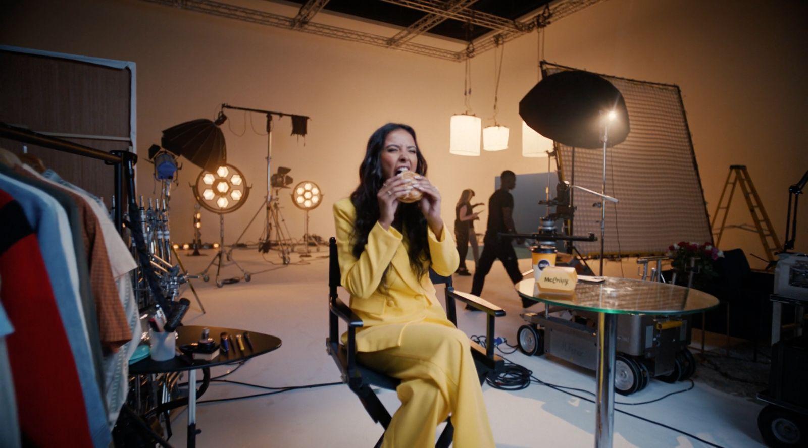a woman sitting in a chair in front of a camera