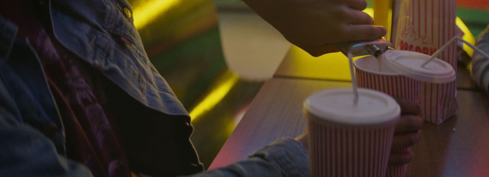 a person is pouring something into a cup