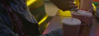 a person is pouring something into a cup