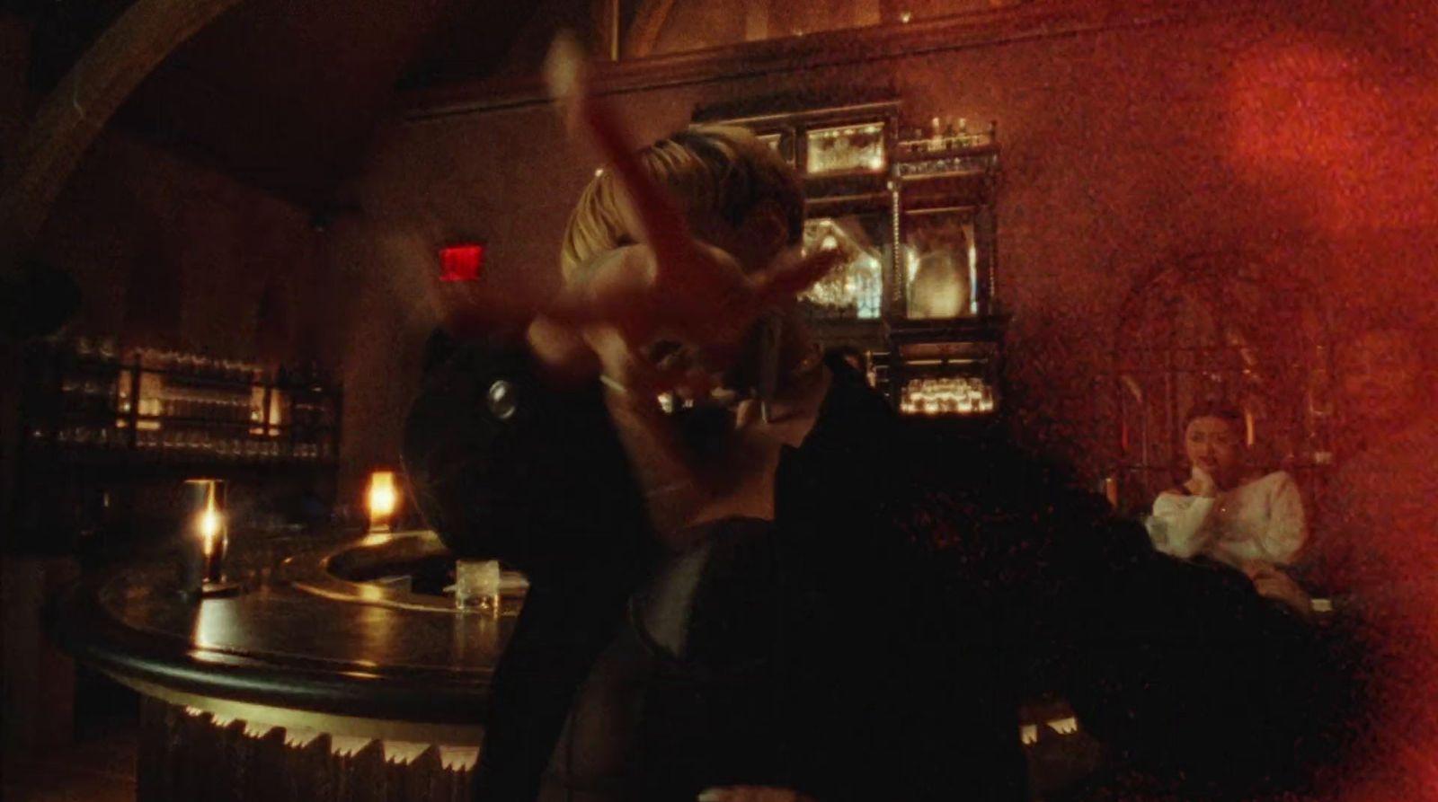 a woman is dancing in a dimly lit room