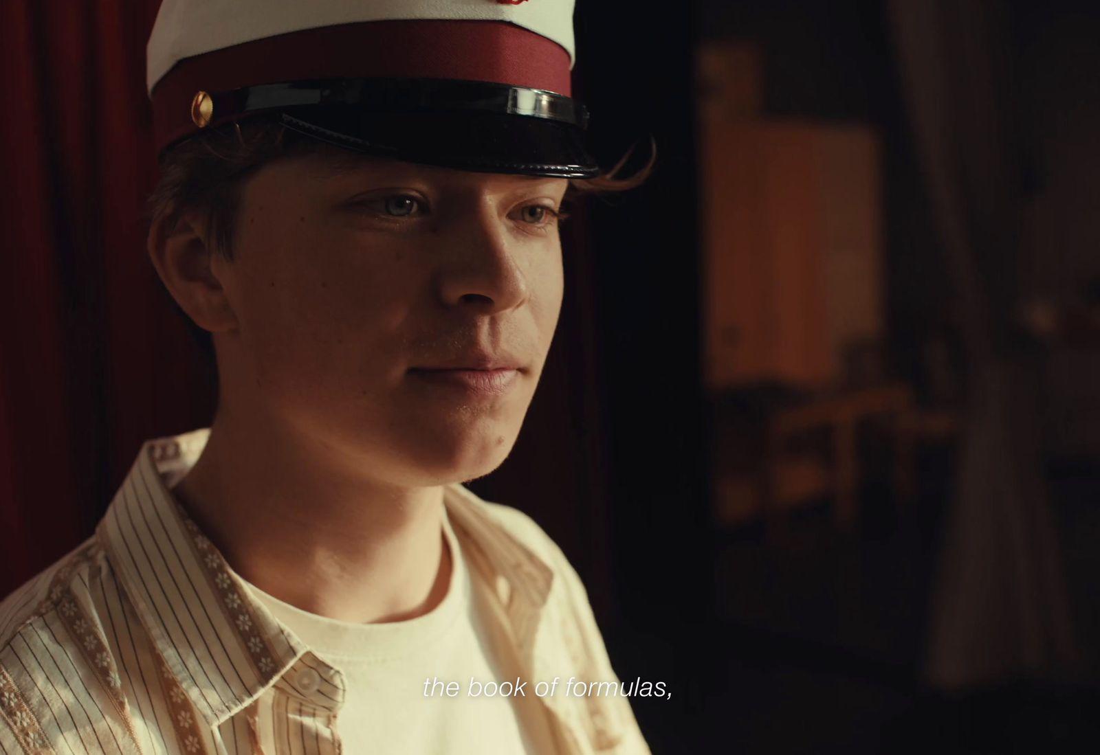 a young man wearing a red and white hat