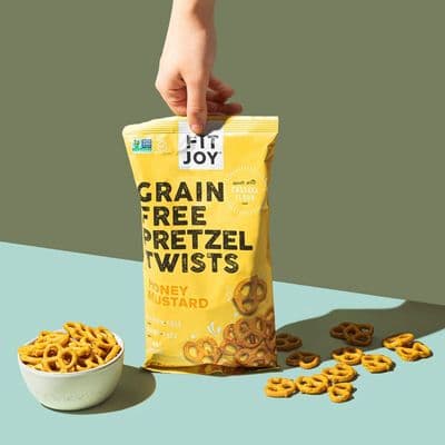 a bag of grain free pretzel twists next to a bowl of pretze