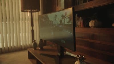 a flat screen tv sitting on top of a wooden table