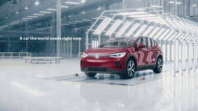 a red car is parked in a large building