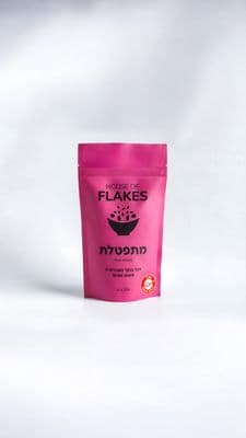 a pink bag of flakes on a white background