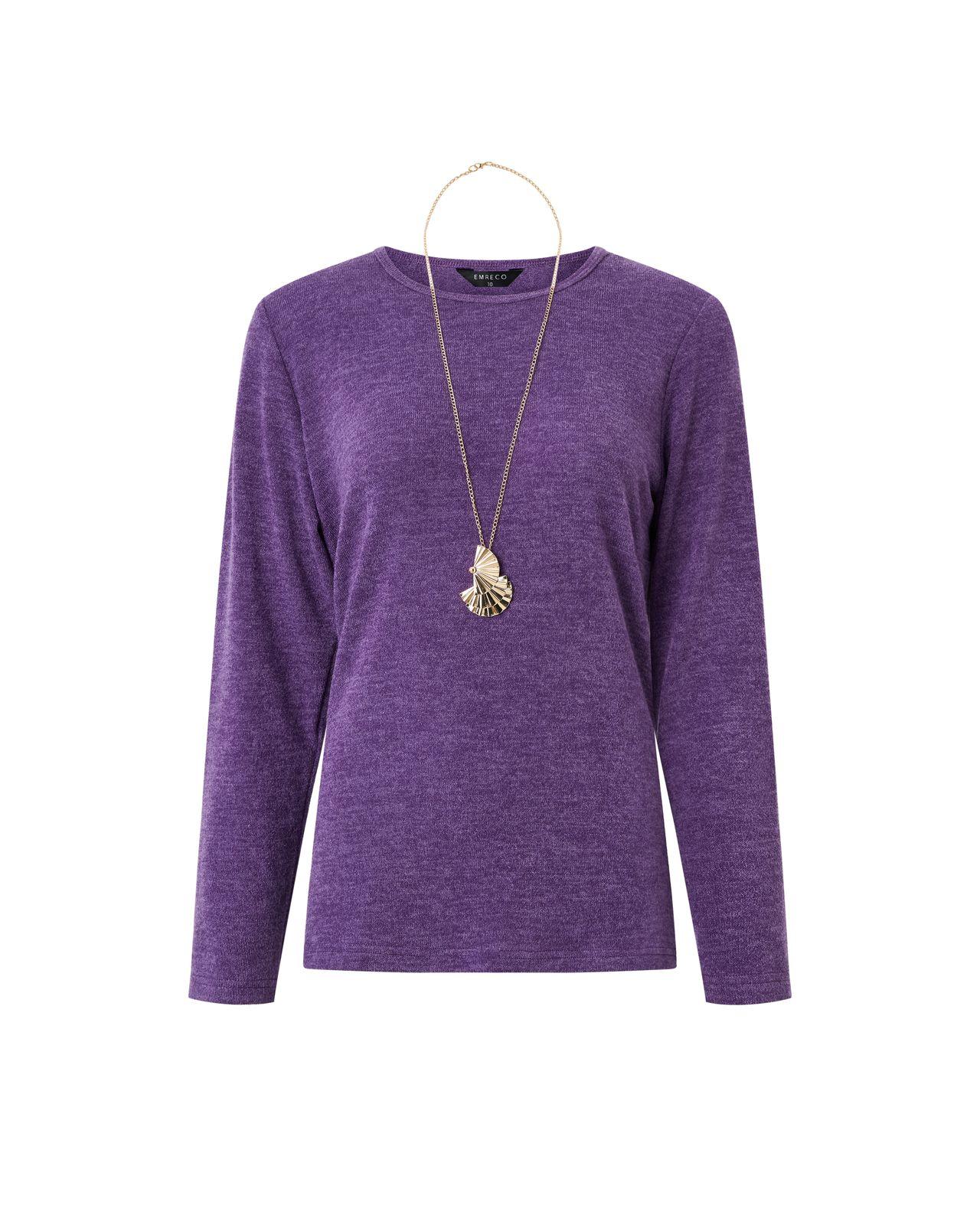 a woman wearing a purple sweater and a necklace