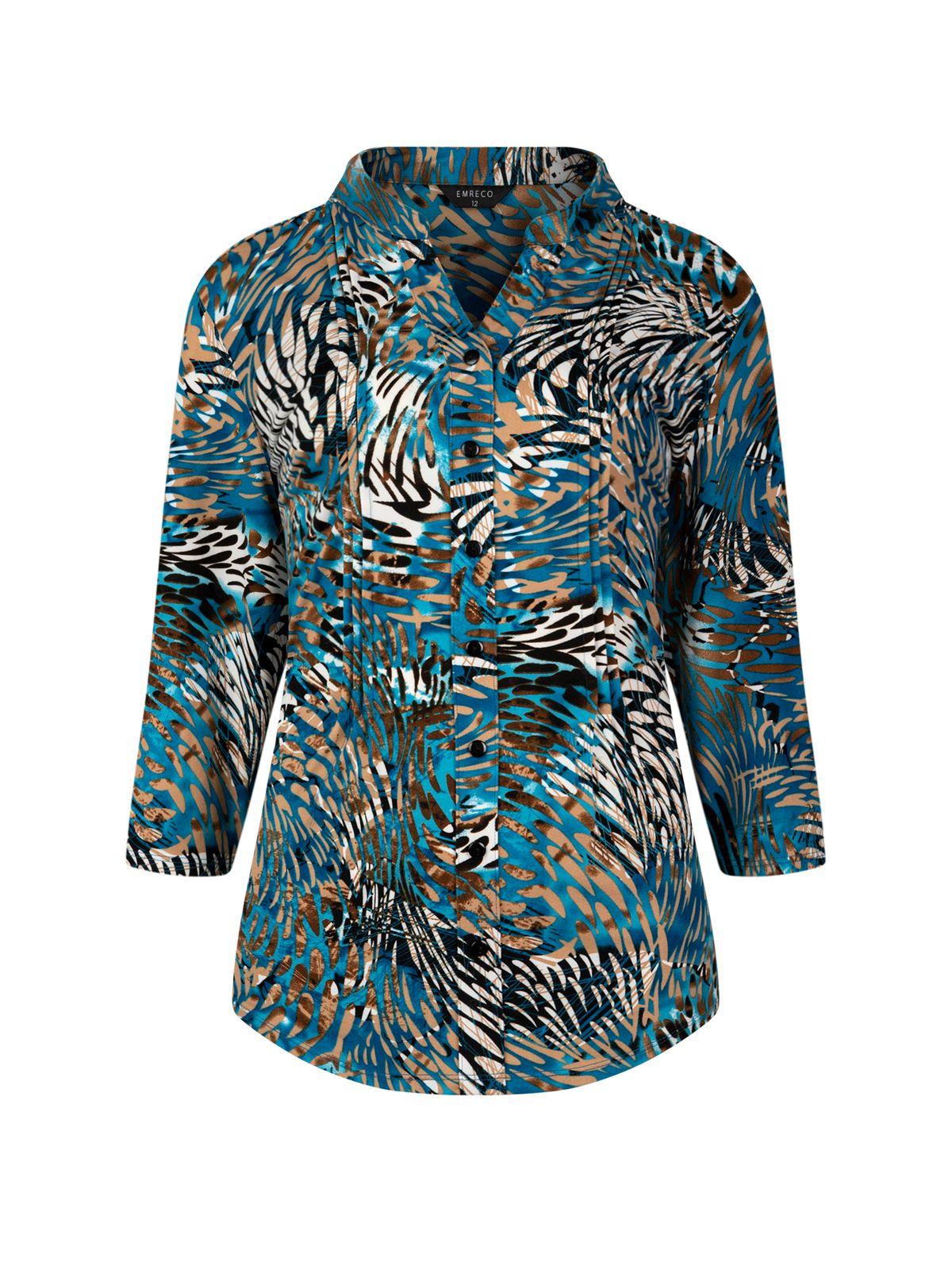 a woman wearing a blue and black shirt with a pattern on it
