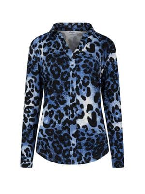 a woman wearing a blue and black leopard print shirt