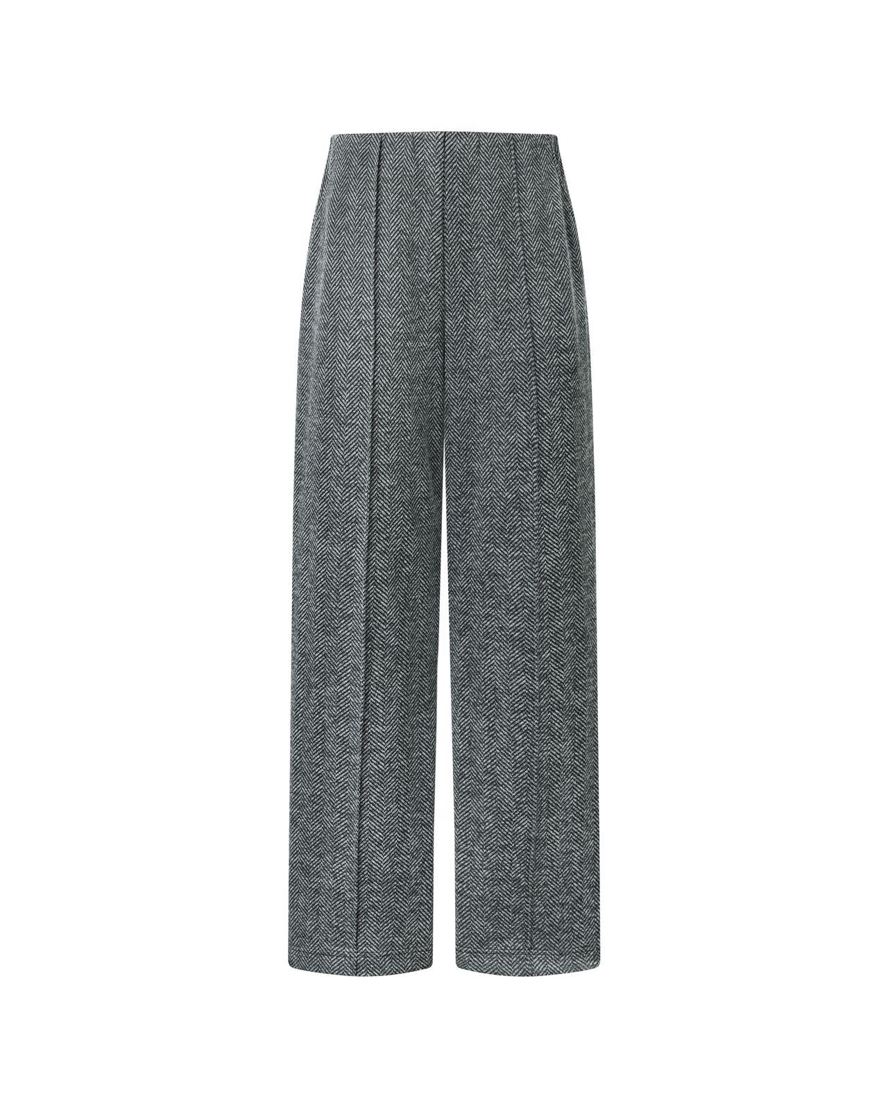 a woman is wearing grey pants and a white shirt