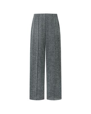 a woman is wearing grey pants and a white shirt