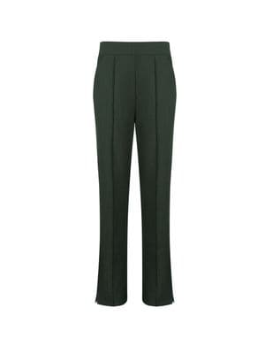 a woman wearing a green pants and a white shirt